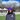 RUSU Beanie in purple with white RUSU embroidered logo modelled by male student outside on the green grass at RMIT University in the Melbourne CBD.