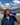RUSU Water Bottle in puprple with a white printerd RUSU logo. Female student drinking from the bottle.